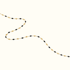 DUGO dainty enamel beaded bracelet featuring glossy black oval beads on a delicate gold chain