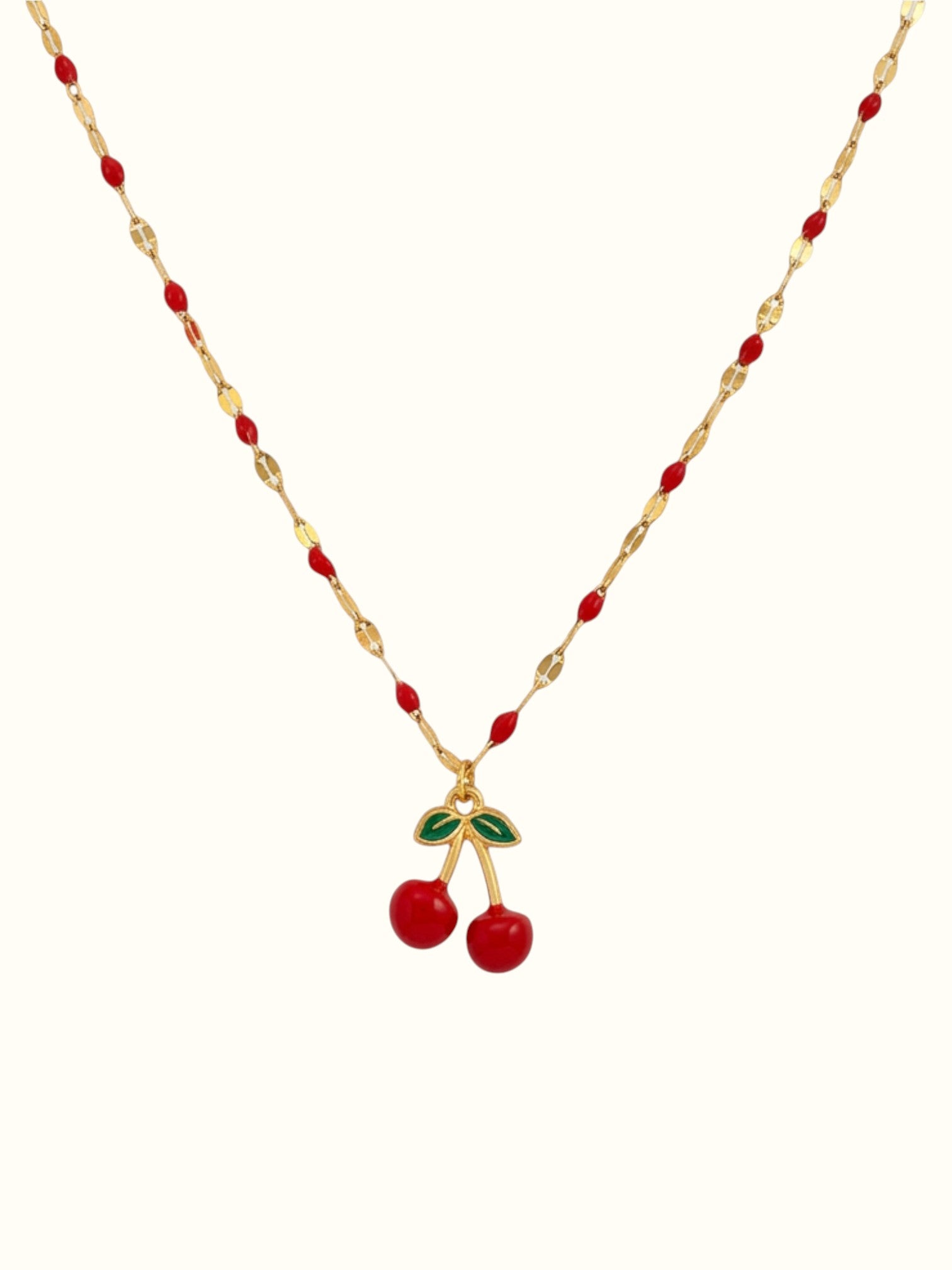 DUGO cherry red necklace featuring a gold chain with red enamel accents and a dangling cherry charm with green leaves