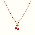 DUGO cherry red necklace featuring a gold chain with red enamel accents and a dangling cherry charm with green leaves