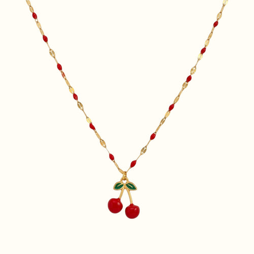 DUGO cherry red necklace featuring a gold chain with red enamel accents and a dangling cherry charm with green leaves