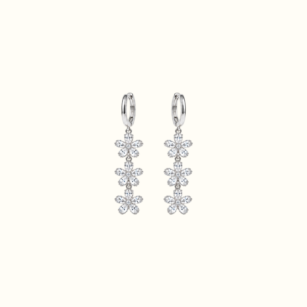 DUGO silver triple crystal flower drop earrings featuring cascading floral charms on sleek hoops.