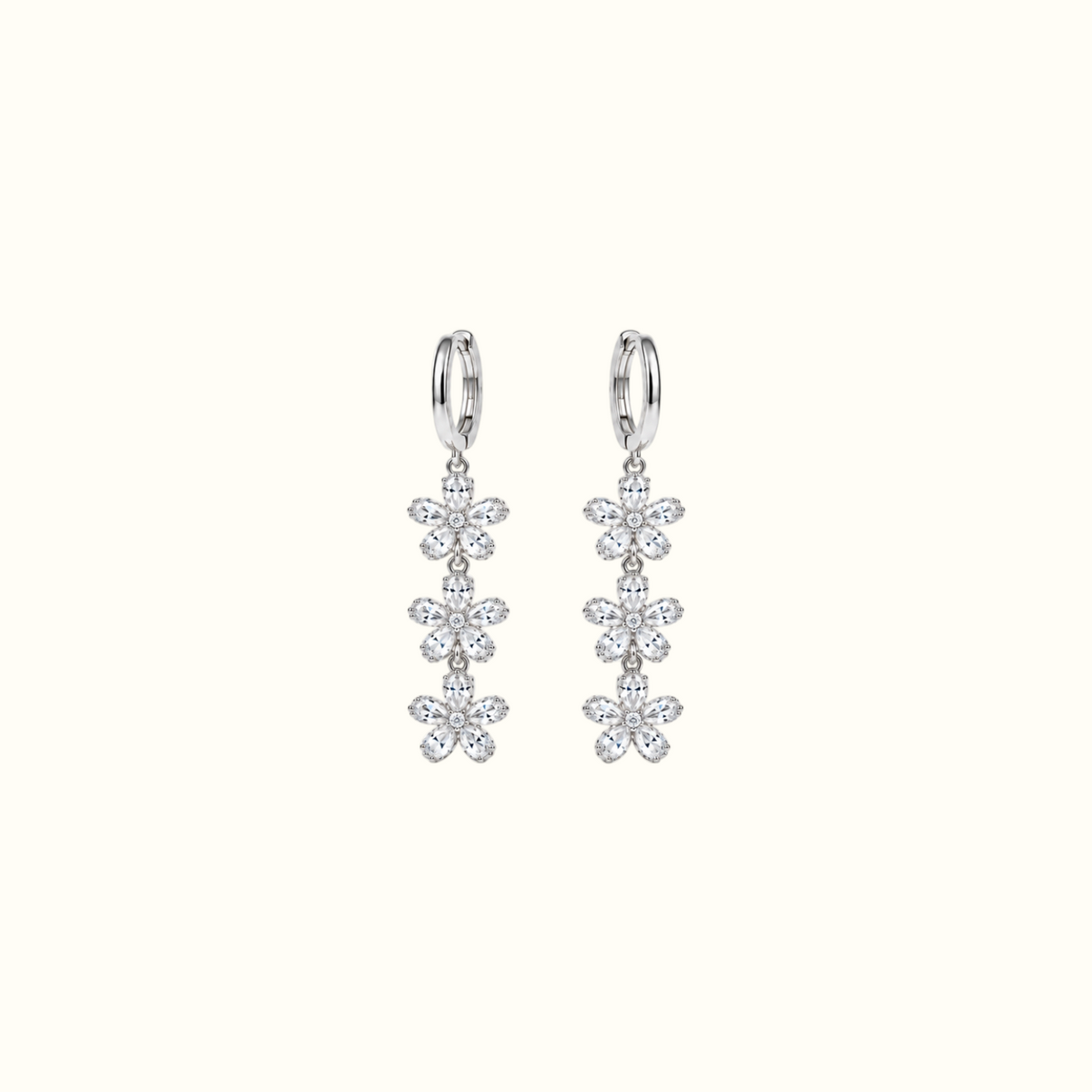 DUGO silver triple crystal flower drop earrings featuring cascading floral charms on sleek hoops.
