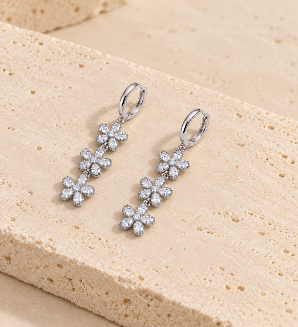 DUGO Crystal Flower Drop Earrings on travertine stone