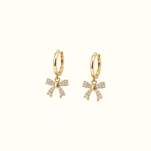 DUGO gold huggie earrings featuring dangling crystal-encrusted ribbon bows for an elegant feminine look.