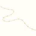 DUGO dainty enamel beaded bracelet featuring white glossy oval beads on a delicate gold chain for minimalist styling.