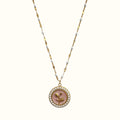 DUGO gold necklace featuring a round pendant with a pink flower motif surrounded by small white pearls on a beaded chain
