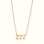 DUGO gold-toned lucky number 777 pendant necklace on a delicate curb chain