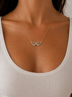 Woman wearing the DUGO gold Angel Wings Zirconia Necklace
