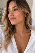 Close-up of the DUGO gold Baguette Crystal Y Lariat Necklace worn on the neck