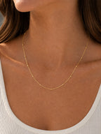 Close-up of the DUGO gold Ball Cable Chain Satellite Bead Necklace worn on the neck
