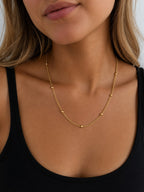 Close-up of the DUGO gold Ball Chain Satellite Bead Necklace worn on the neck