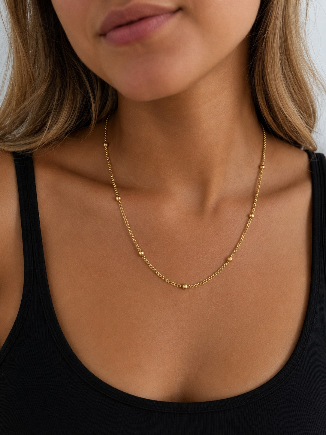 Close-up of the DUGO gold Ball Chain Satellite Bead Necklace worn on the neck