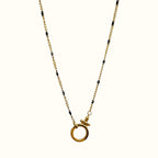 DUGO gold and black chain necklace featuring a minimalist circular spring gate clasp for customizable charm styling.
