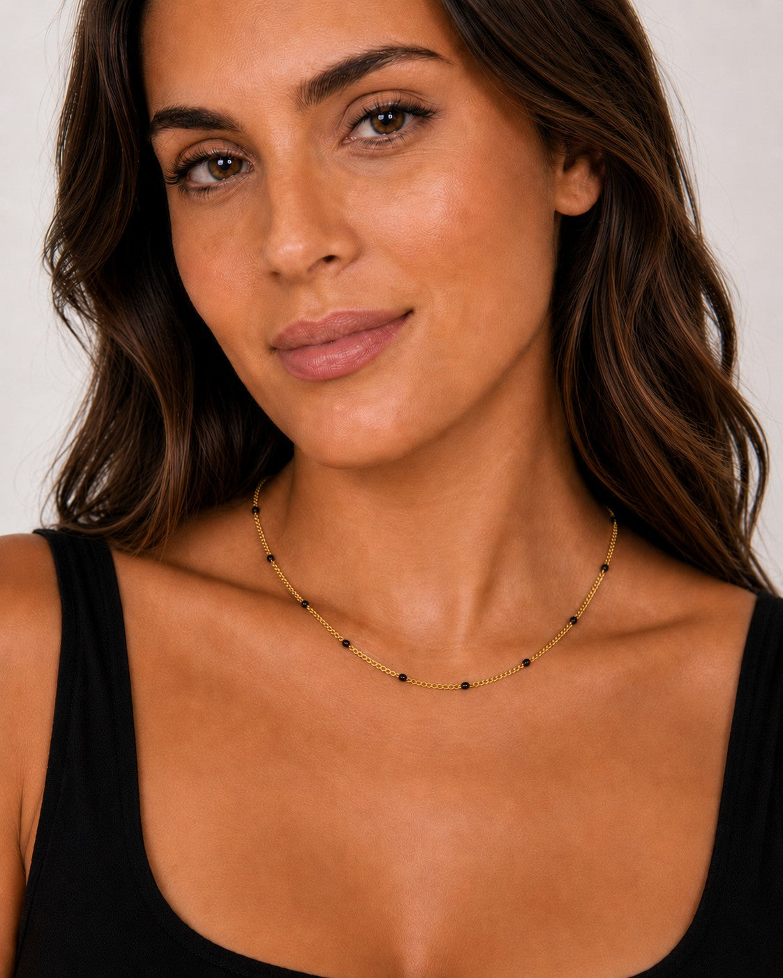 Close-up of the DUGO gold black Enamel Curb Chain Necklace worn on the neck