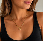 Woman wearing the DUGO gold Black Enamel Spring Gate Necklace