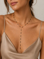 Woman wearing the DUGO gold black Enamel Y Lariat Necklace