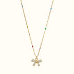 DUGO gold chain necklace featuring a mini bow pendant with sparkling zirconia stones and colorful enamel accents