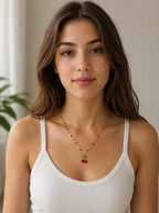 Close-up of the DUGO gold Cherry Red Necklace worn on the neck