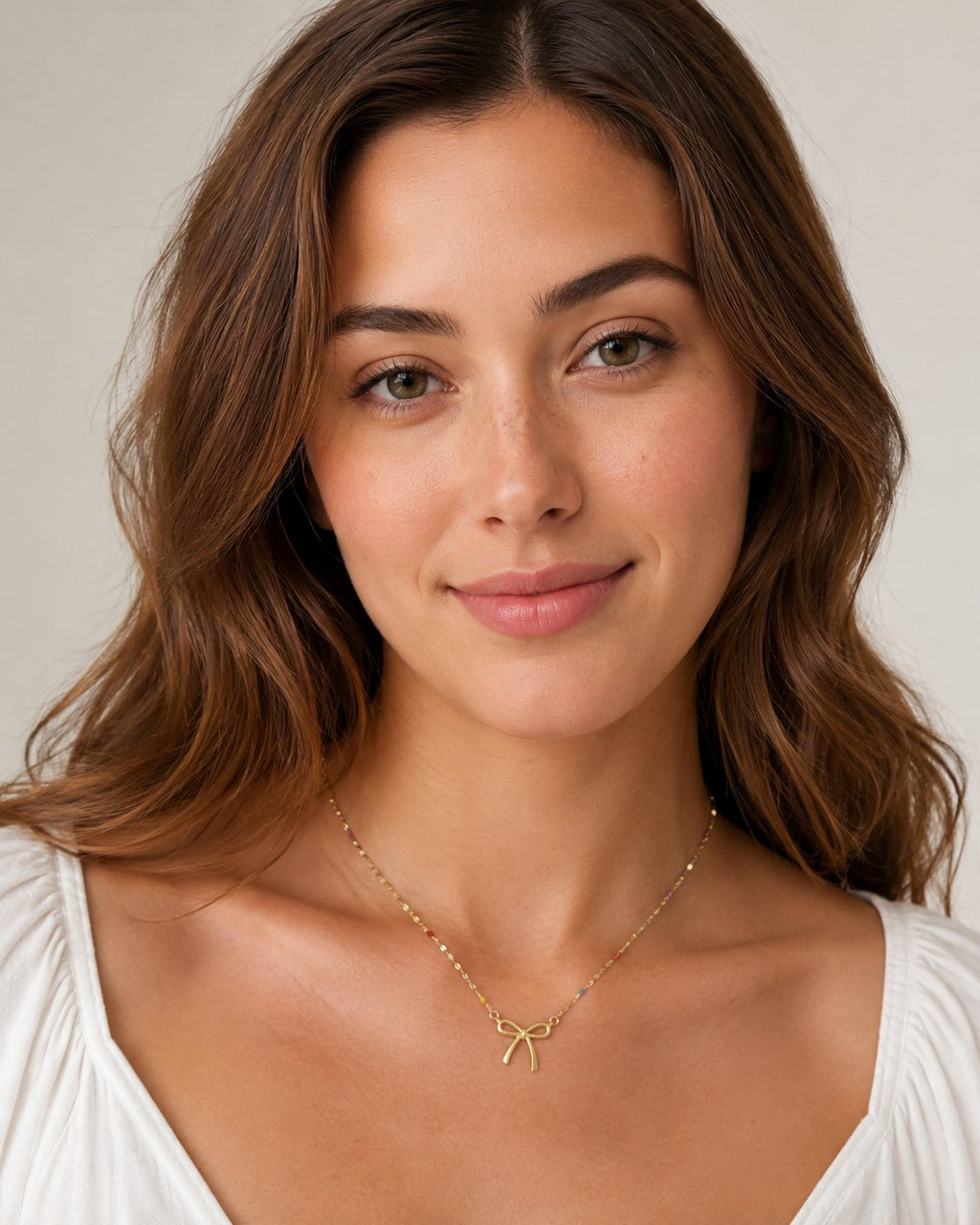 Close-up of the DUGO gold Colorful Enamel Bow Necklace worn on the neck