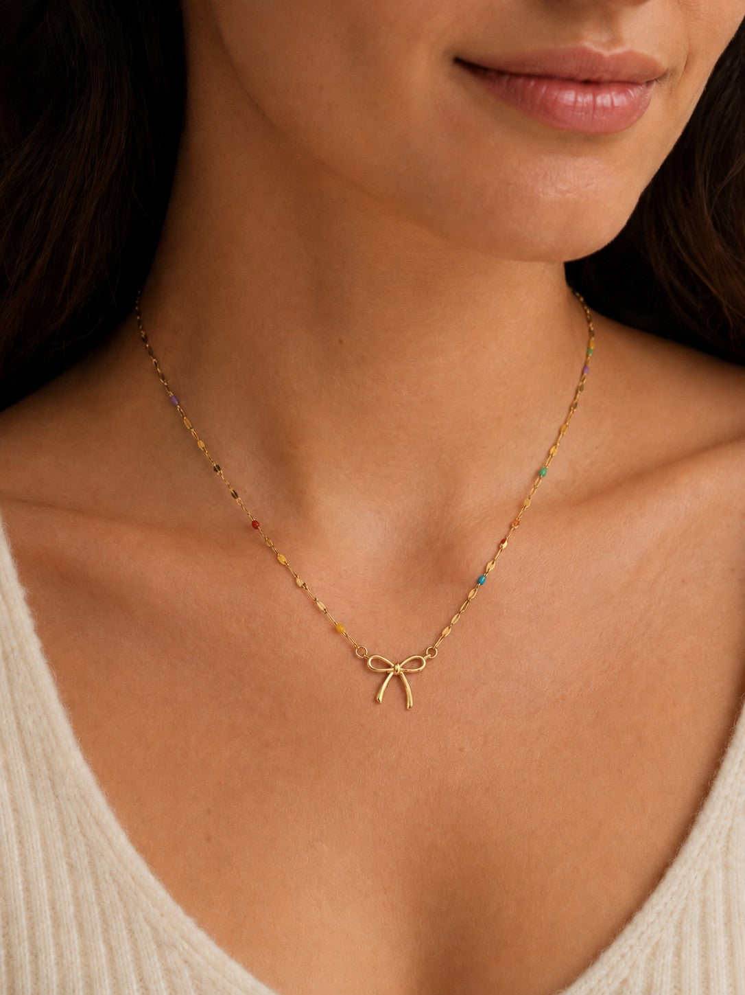 Woman wearing the DUGO gold Colorful Enamel Bow Necklace