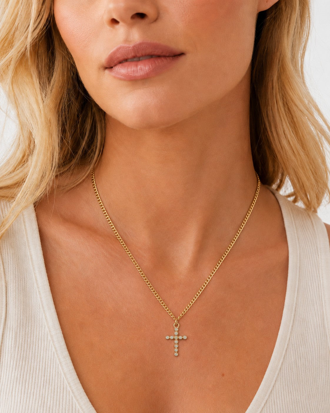 Woman wearing the DUGO gold Cross Dainty Necklace