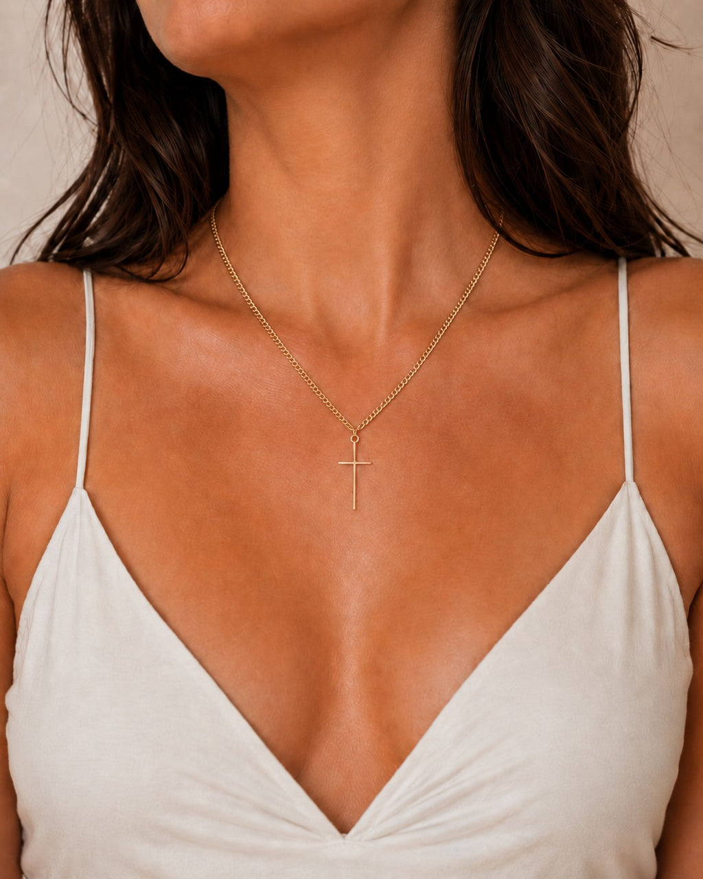 Woman wearing the DUGO gold Cross Tiny Necklace