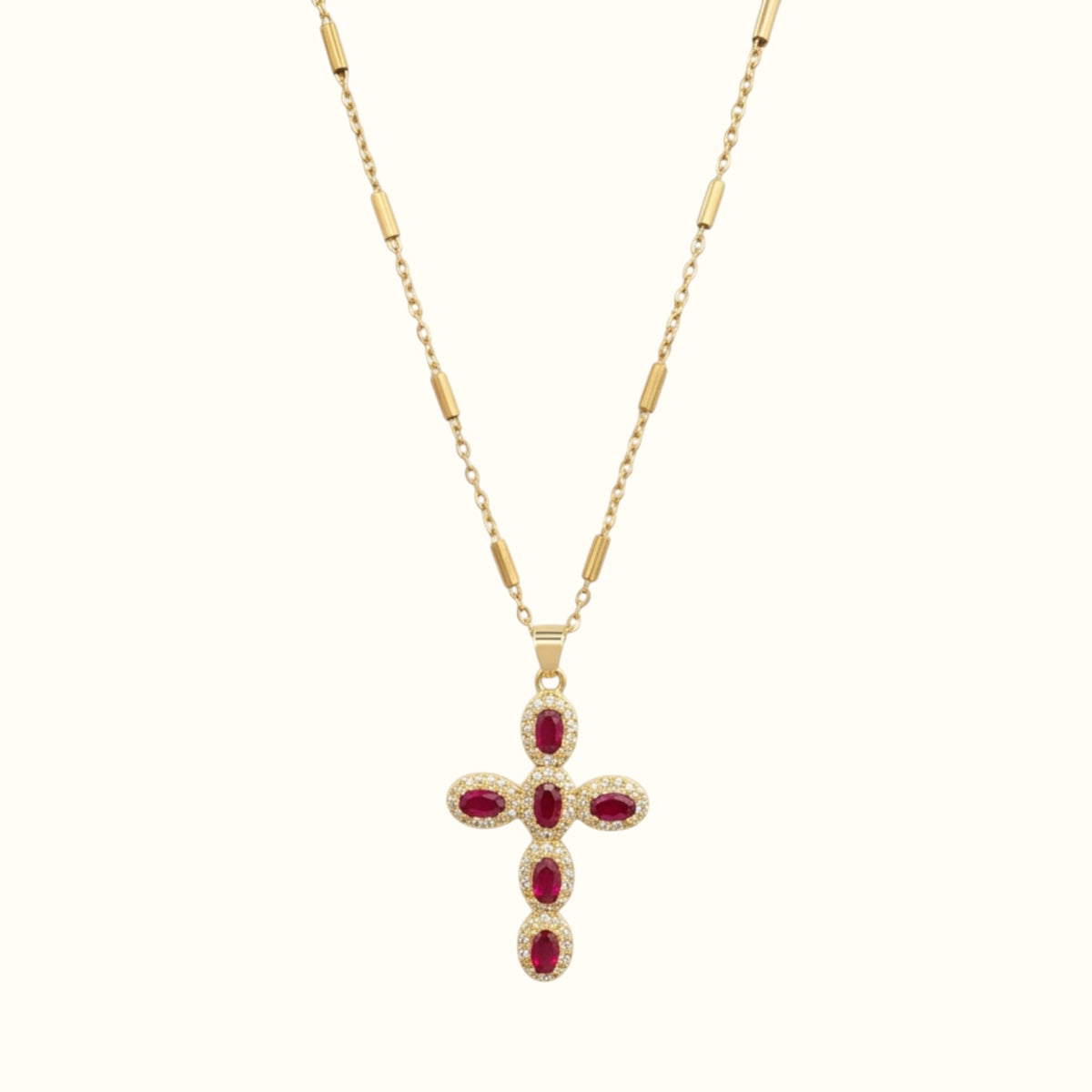 DUGO gold cross necklace featuring oval red zirconia stones and pave crystal accents on a delicate chain