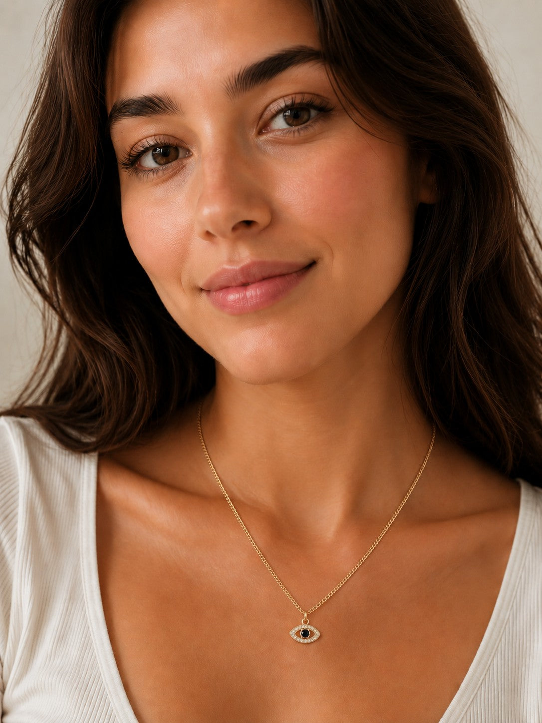 Close-up of the DUGO gold Evil Eye Zircon Necklace worn on the neck