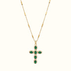 DUGO gold cross necklace featuring oval green zirconia stones surrounded by delicate pave crystals on a bar chain