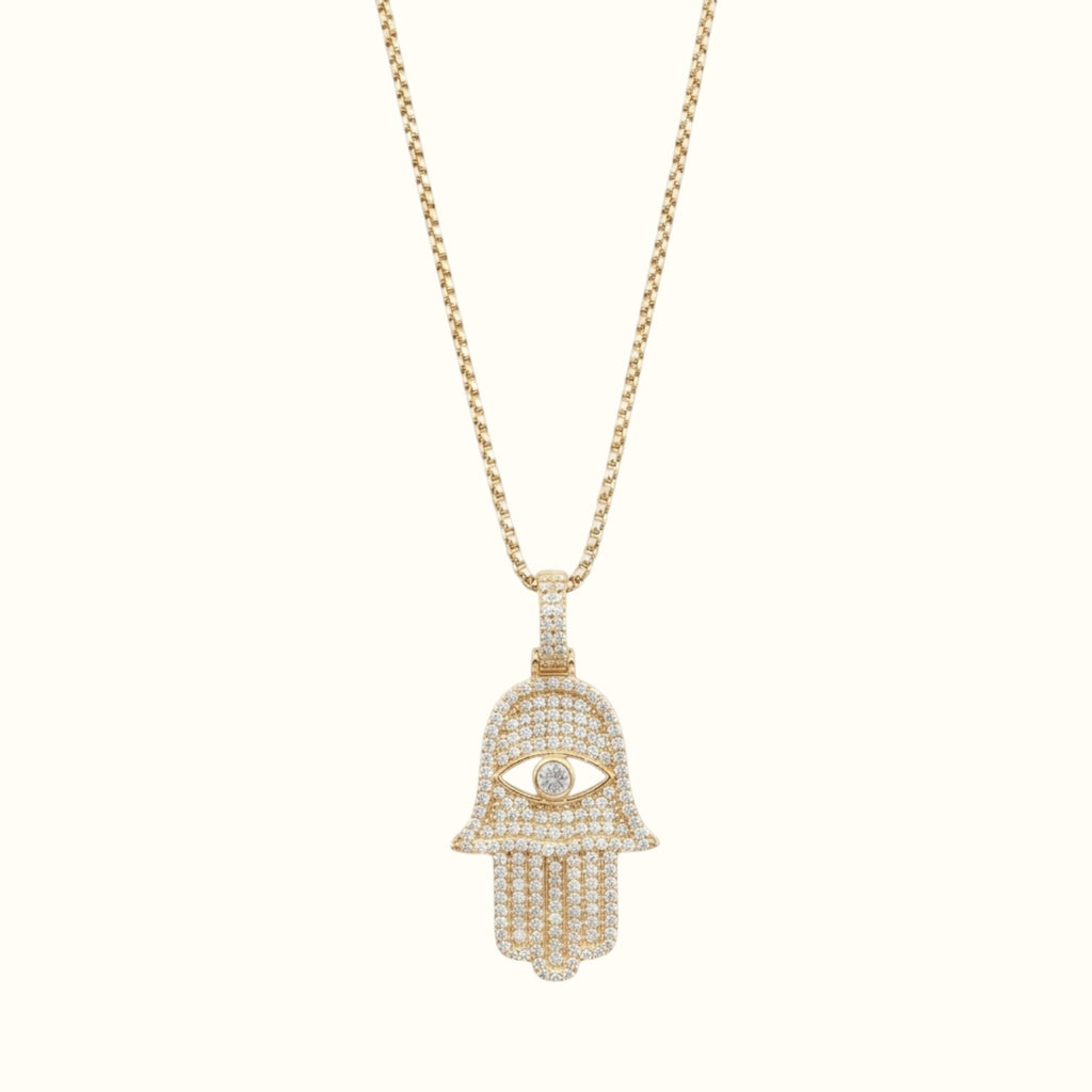 DUGO gold Hamsa hand evil eye pendant necklace featuring sparkling cubic zirconia stones on a delicate chain