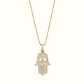 DUGO gold Hamsa hand evil eye pendant necklace featuring sparkling cubic zirconia stones on a delicate chain