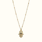 DUGO 18K gold filled Hamsa hand necklace featuring a cubic zirconia pendant with a black evil eye center