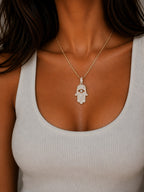 Woman wearing the DUGO gold Hamsa Large Necklace
