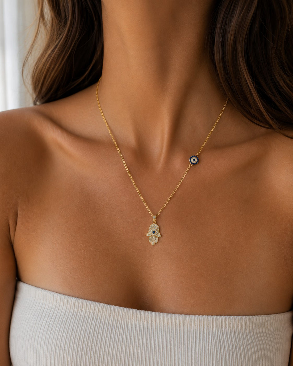 Woman wearing the DUGO gold Hamsa with Evil Eye Charm Necklace