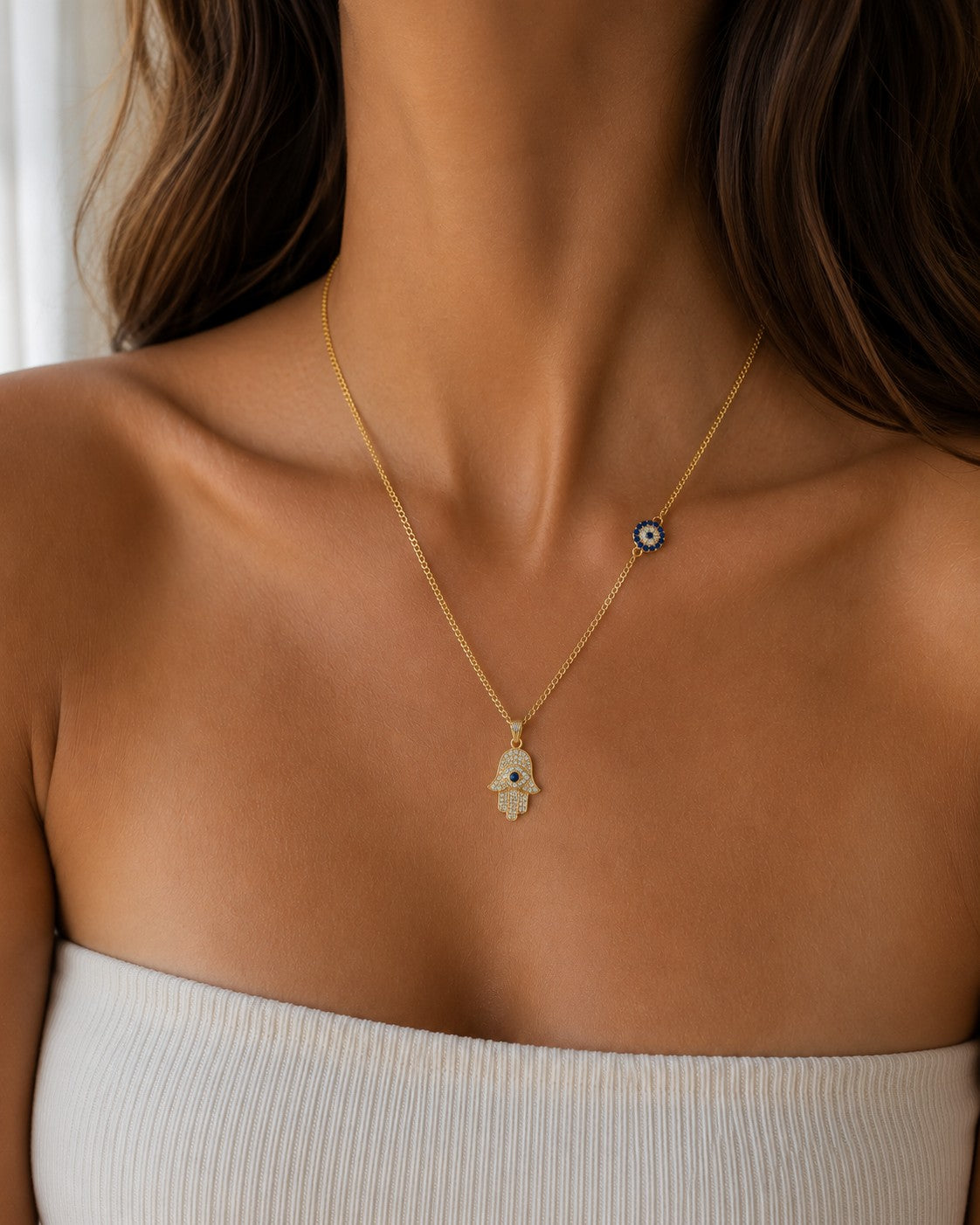 Woman wearing the DUGO gold Hamsa with Evil Eye Charm Necklace