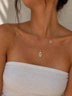Woman wearing the DUGO gold Hamsa with Star David Charm Necklace