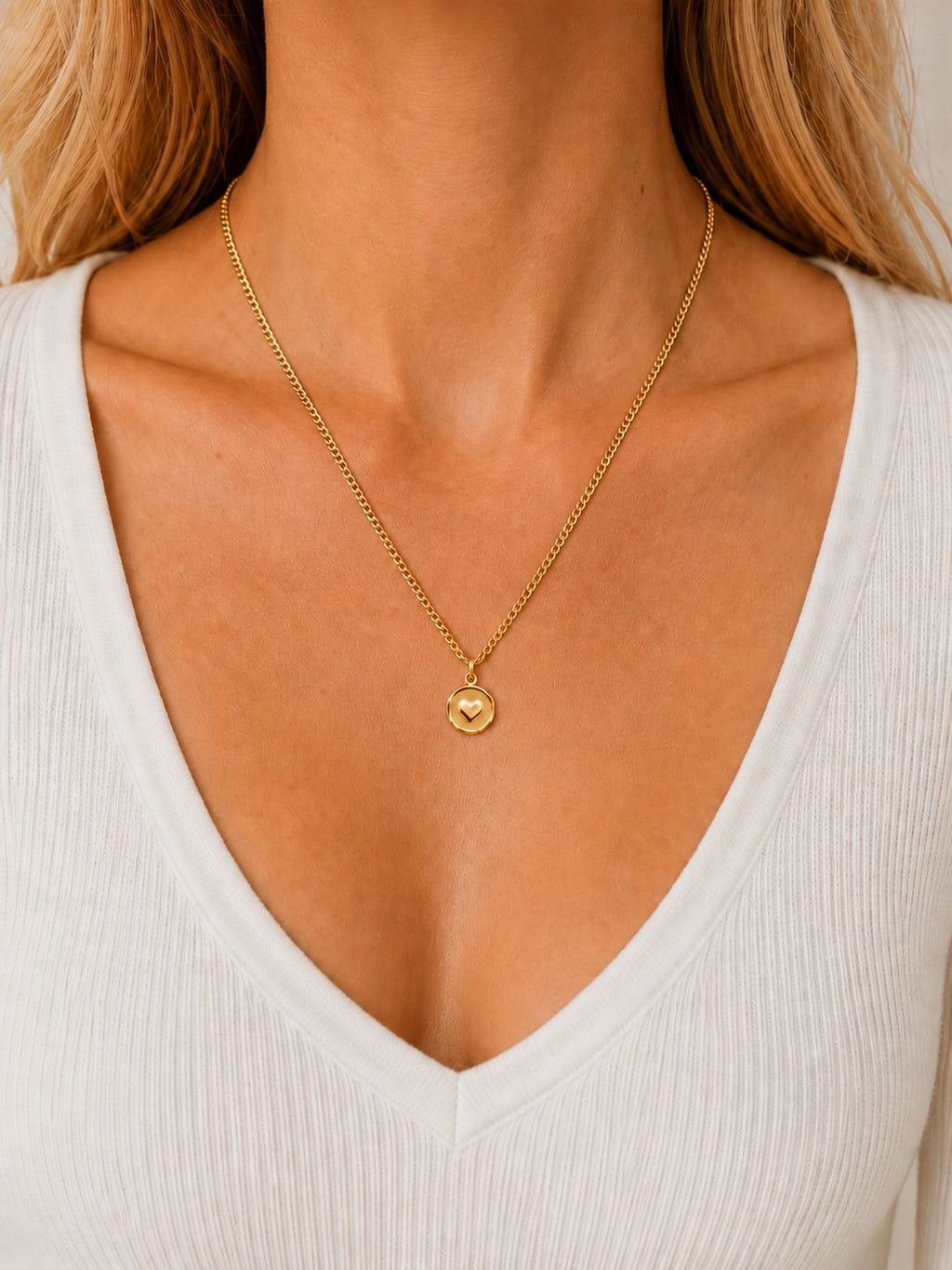 Woman wearing the DUGO gold Heart Coin Necklace