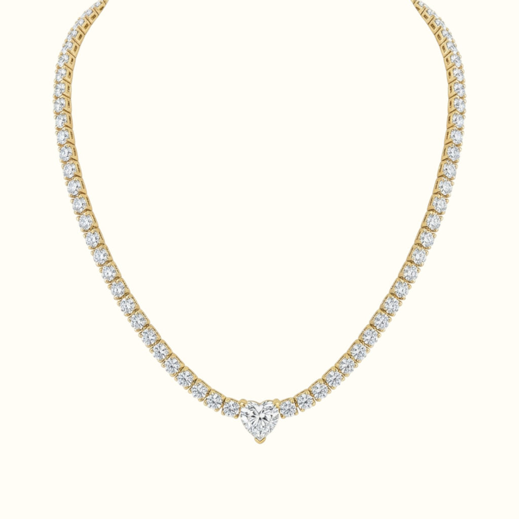 DUGO gold tennis necklace featuring a sparkling heart-shaped cubic zirconia center stone and shimmering link chain.