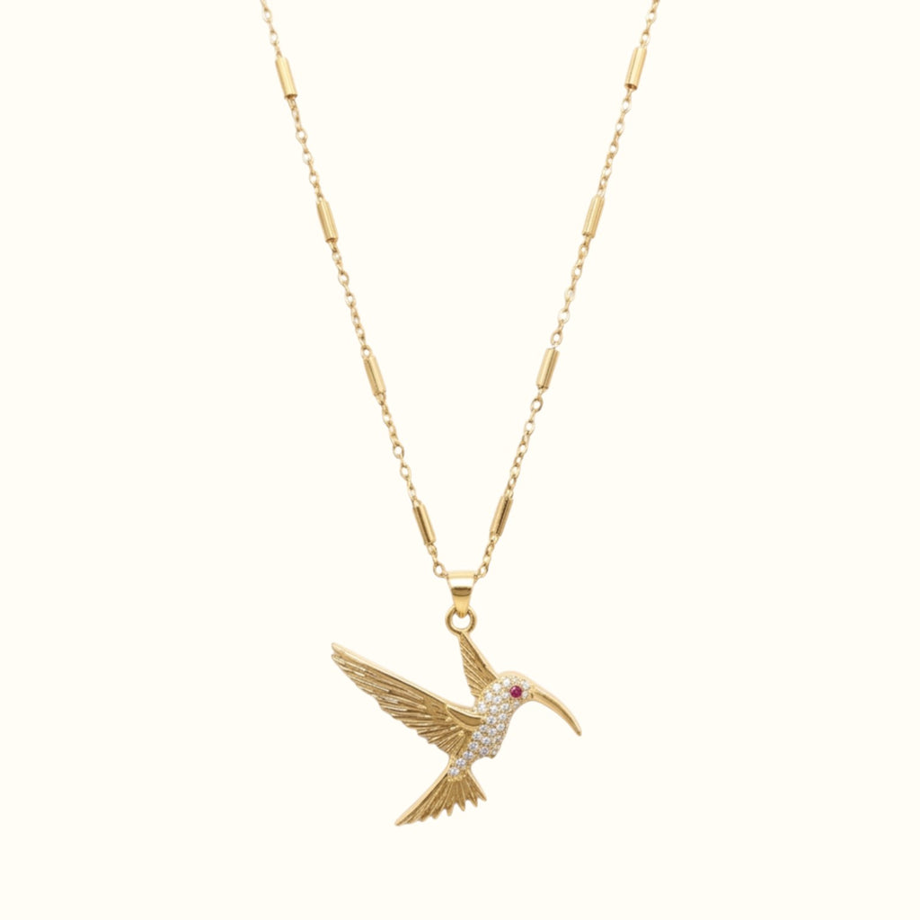 DUGO gold hummingbird pendant necklace featuring a delicate tube chain and sparkling crystal accents.