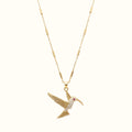 DUGO gold hummingbird pendant necklace featuring a delicate tube chain and sparkling crystal accents.