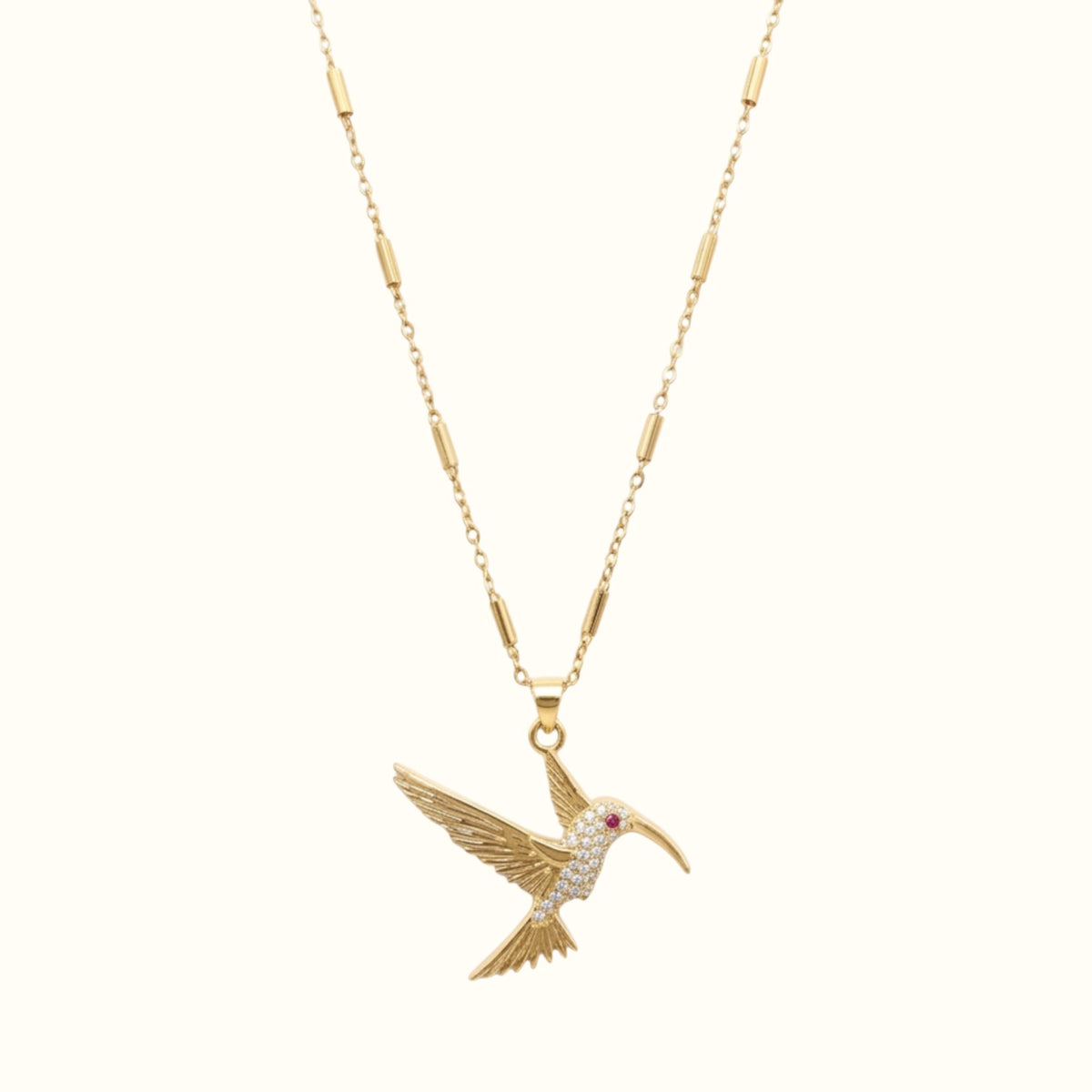 DUGO gold hummingbird pendant necklace featuring a delicate tube chain and sparkling crystal accents.