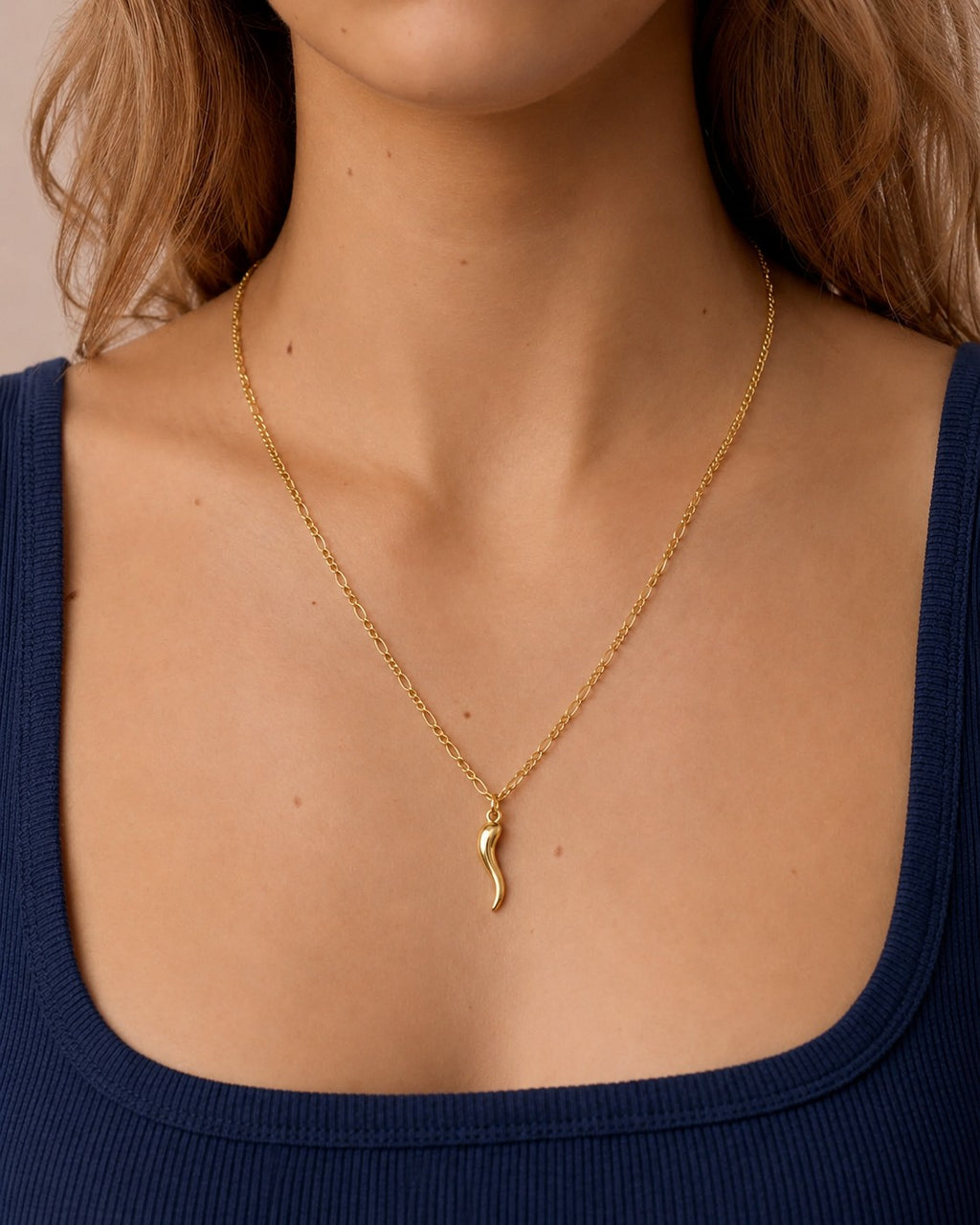 Woman wearing the DUGO gold Italian Horn Necklace