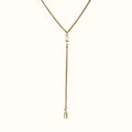 DUGO gold lariat Y necklace featuring a thin Cuban chain and two clear baguette-cut cubic zirconia stones.
