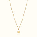 DUGO gold lock pendant necklace on a delicate beaded chain, crafted from tarnish-resistant 18K gold filled metal.