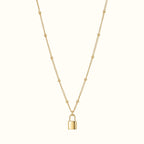 DUGO gold lock pendant necklace on a delicate beaded chain, crafted from tarnish-resistant 18K gold filled metal.
