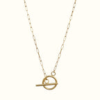 DUGO 18K gold filled paperclip chain necklace with a modern geometric toggle circle pendant on a light background.
