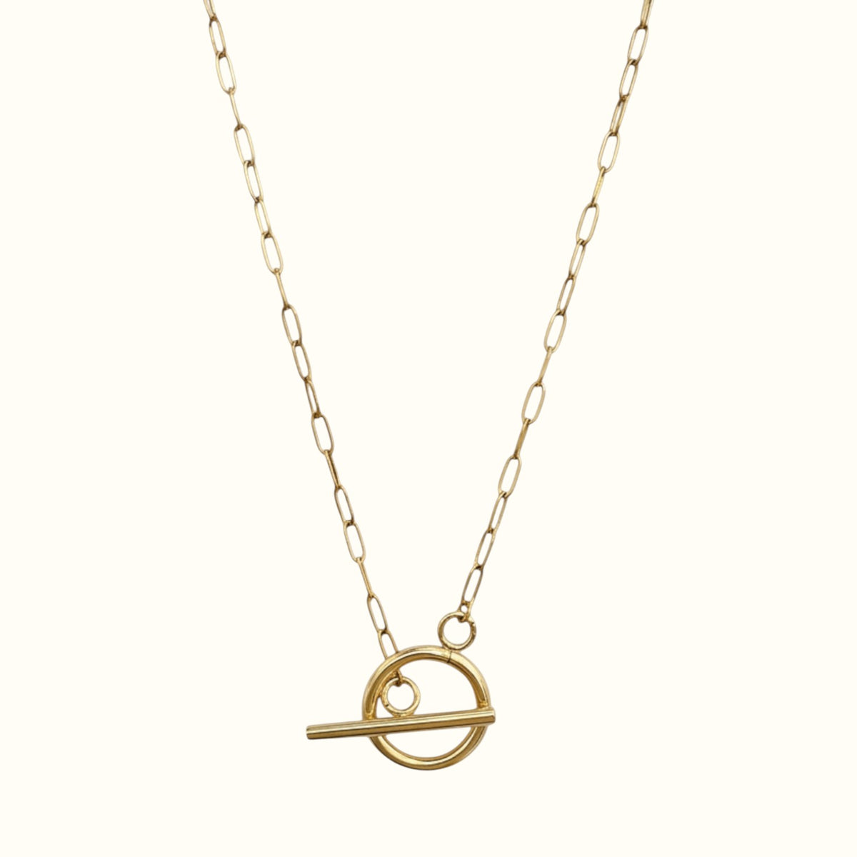 DUGO 18K gold filled paperclip chain necklace with a modern geometric toggle circle pendant on a light background.