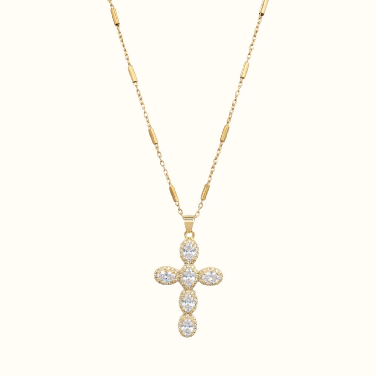DUGO gold cross necklace featuring pave set zirconia stones on a delicate bar link chain