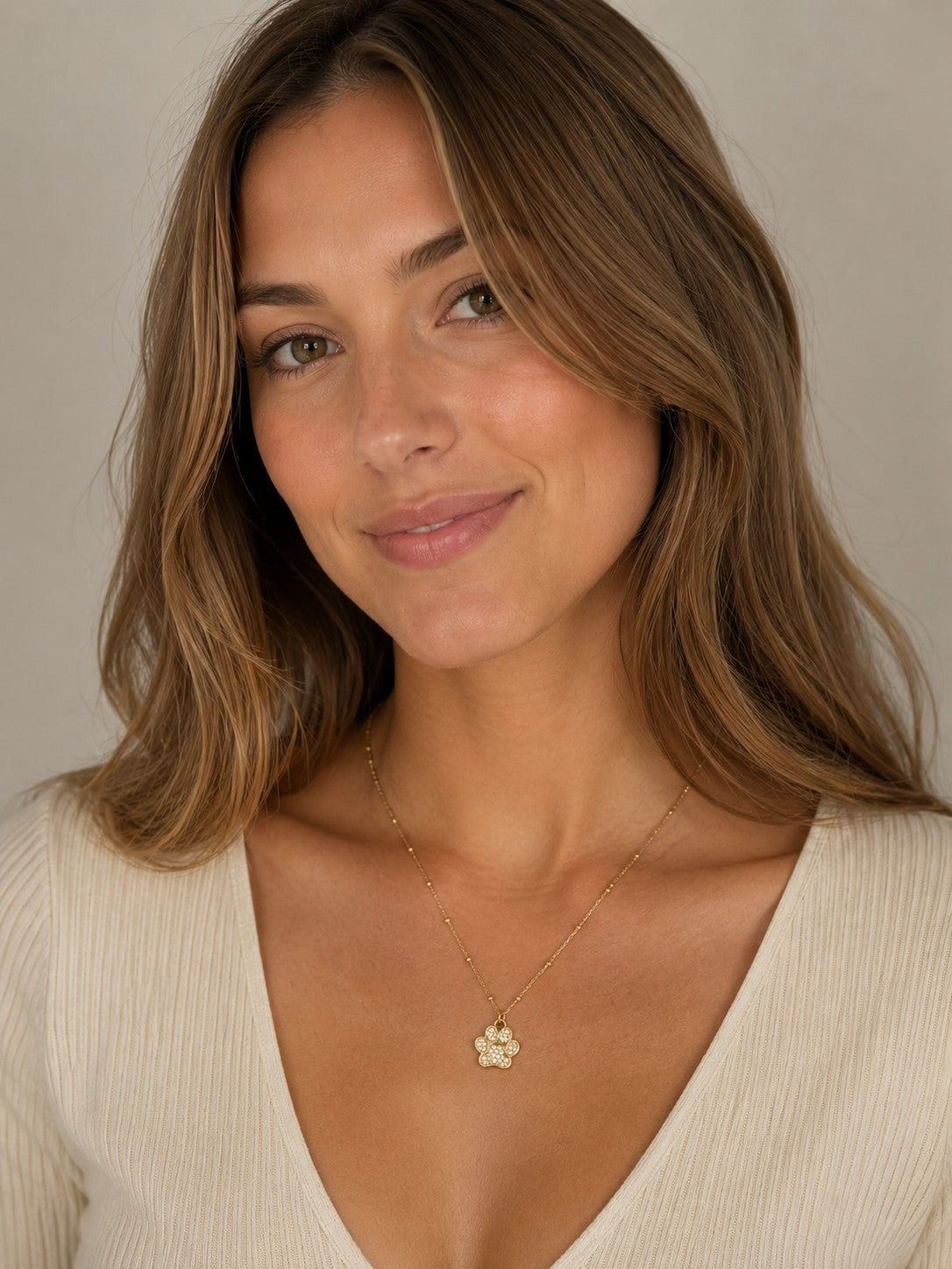 Close-up of the DUGO gold Paw Pendant Necklace worn on the neck