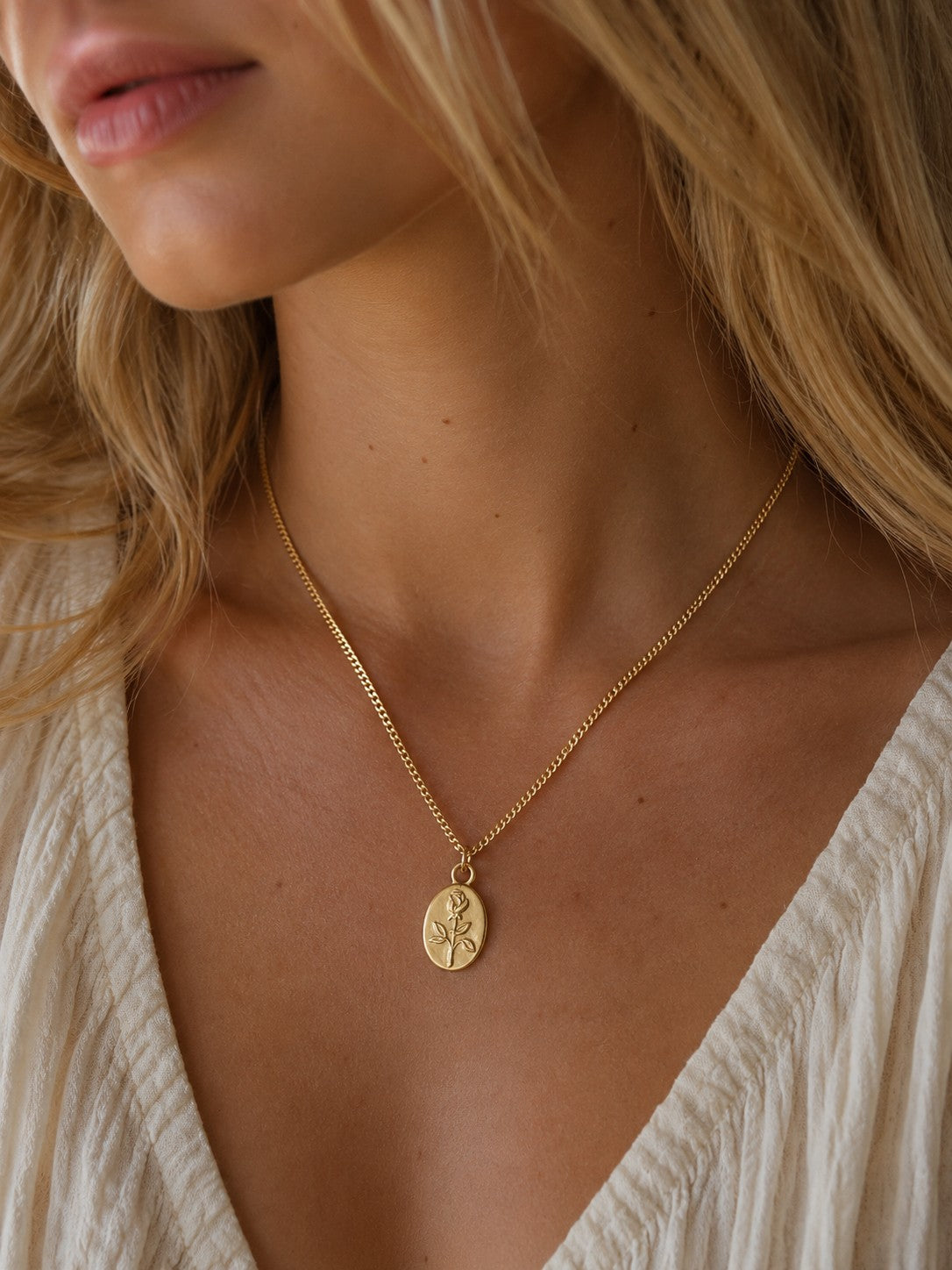 Woman wearing the DUGO gold Rose Medallion Necklace